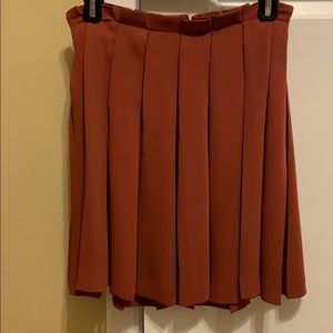 Orange pleated mini skirt